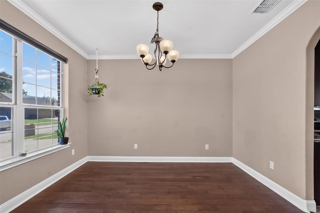 517 Austin Acre Road Sulphur Springs, TX 75482 - Photo 4 of 23 a view of an empty room with wooden floor and a window