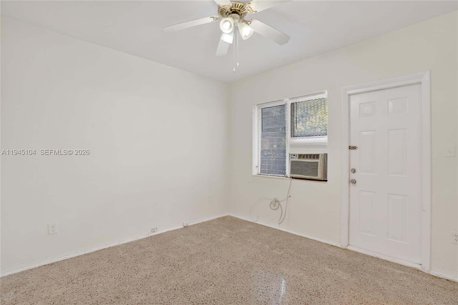 140 Southwest 30th Court, Unit 148 Miami, FL 33135 - Photo 11 of 18 an empty room with windows and fan