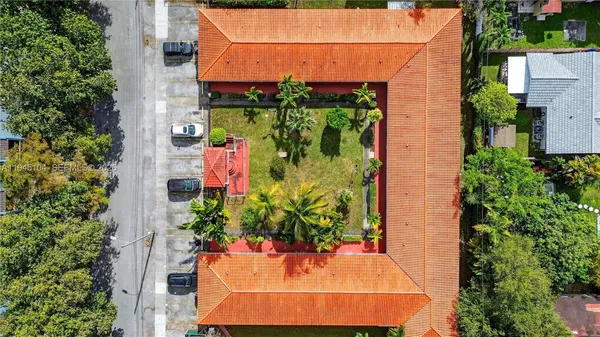 an aerial view of a house with a yard