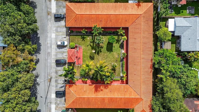 an aerial view of a house with a yard