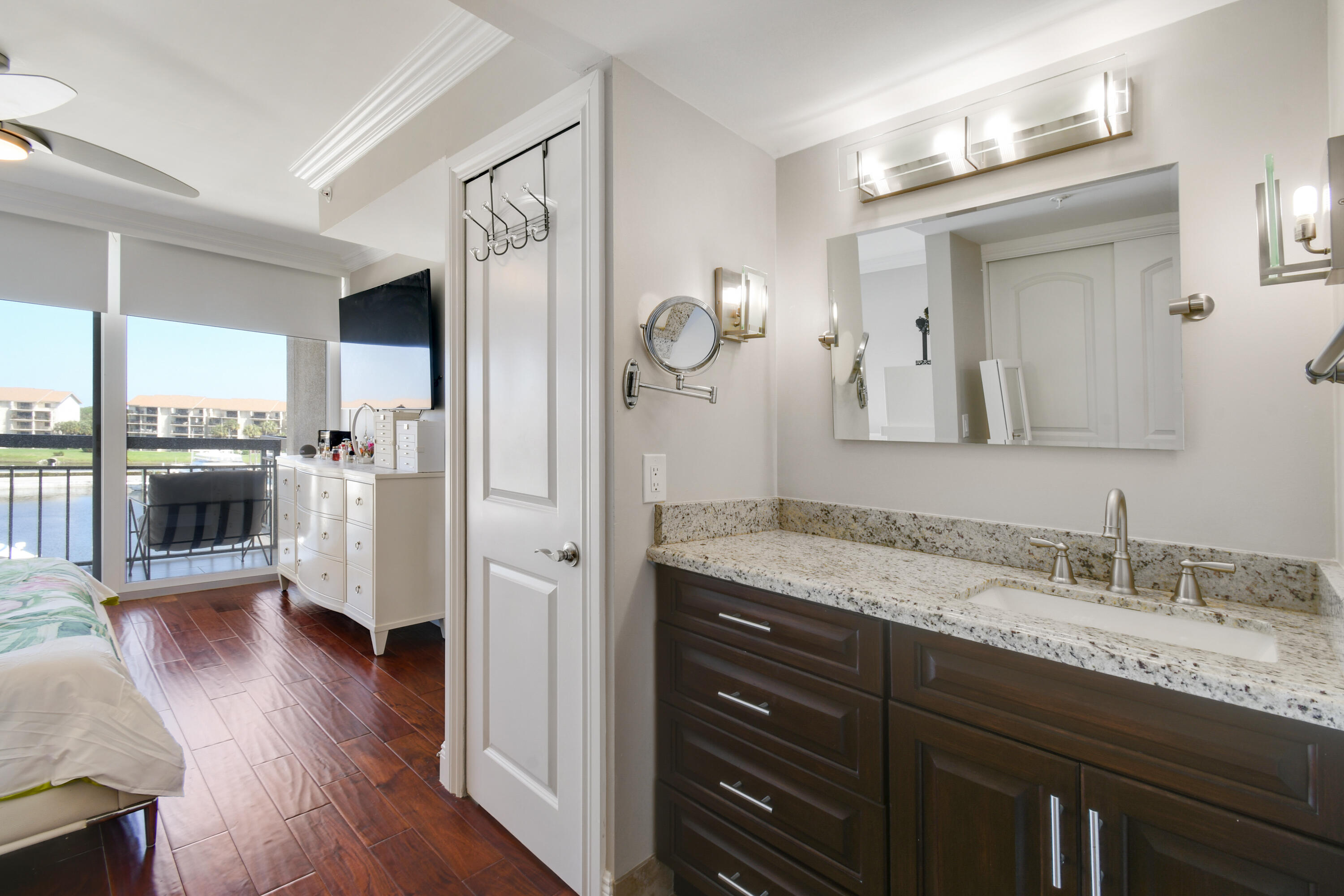 2401 Marina Isle Way, Unit 503 Jupiter, FL 33477 - Photo 22 of 46 a spacious bathroom with a granite countertop sink a mirror a vanity and shower