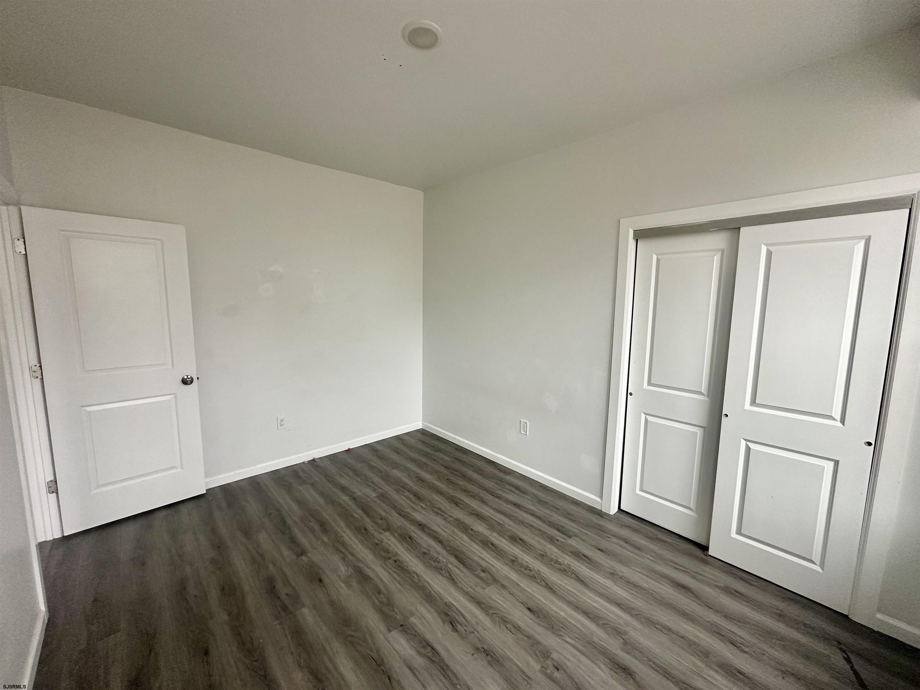 225 Atlantic Avenue, Unit B7 Atlantic City, NJ 08401 - Photo 13 of 28 a view of an empty room with wooden floor