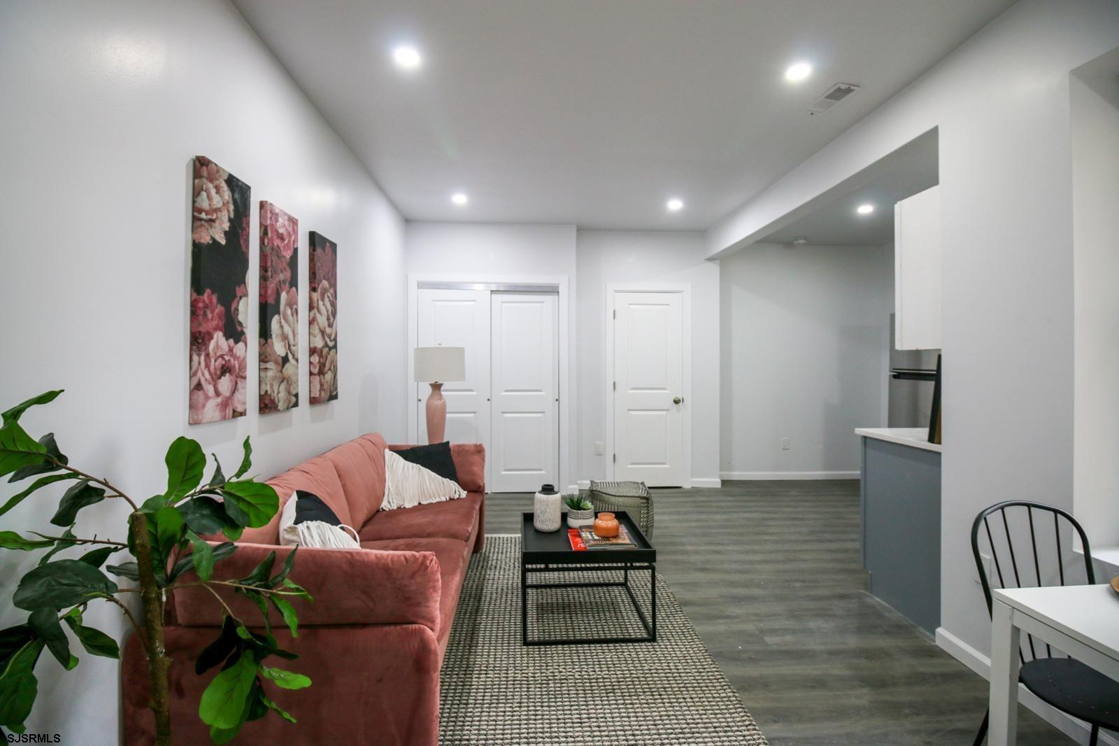 225 Atlantic Avenue, Unit B7 Atlantic City, NJ 08401 - Photo 4 of 28 a living room with furniture and a potted plant