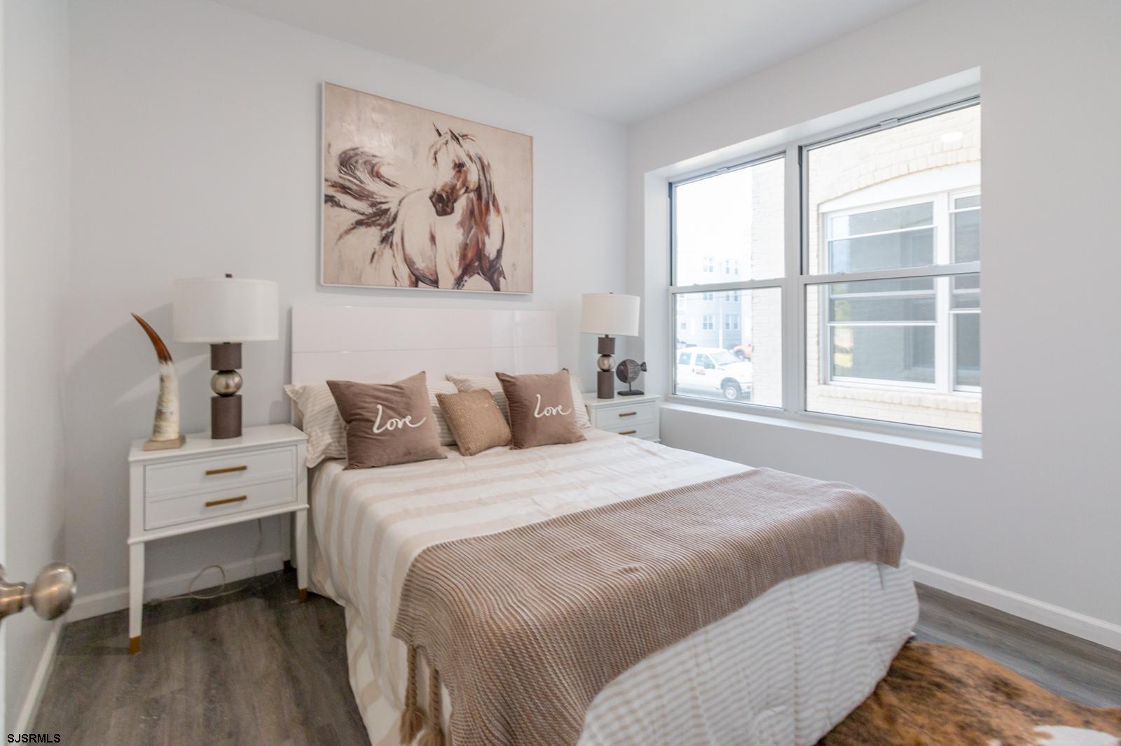 225 Atlantic Avenue, Unit B7 Atlantic City, NJ 08401 - Photo 7 of 28 a bedroom with a bed and a window