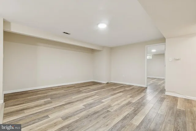 a view of a kitchen with a sink and a refrigerator