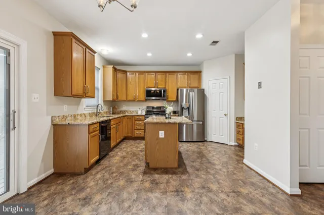 a view of a kitchen with furniture and wooden floor