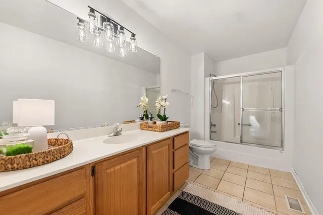 a bathroom with a sink a toilet and mirror