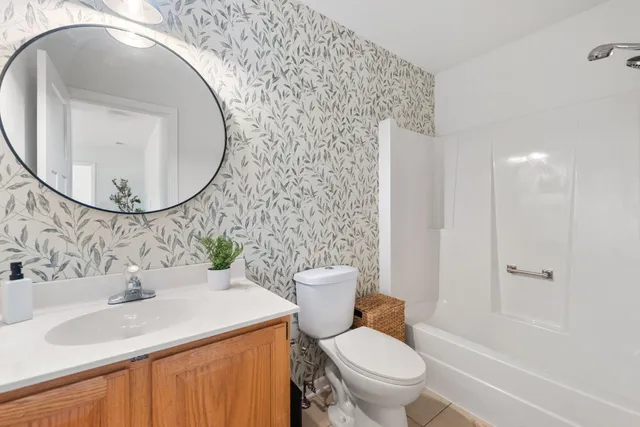 a bathroom with a sink toilet and a mirror