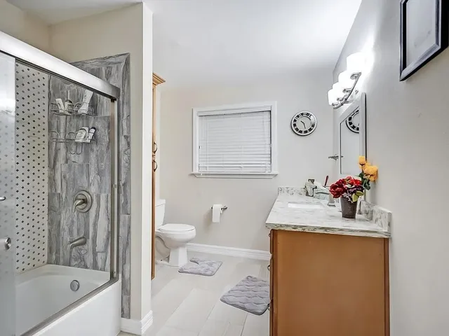 a view of a backyard with table and chairs and potted plants