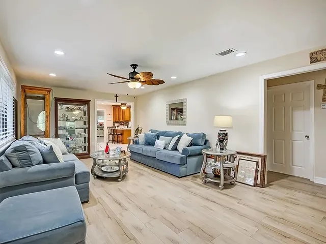 a living room with furniture and wooden floor