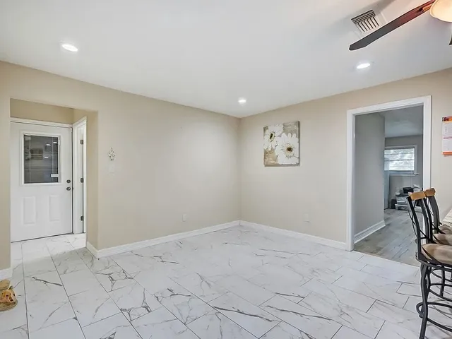 a view of kitchen with furniture and refrigerator