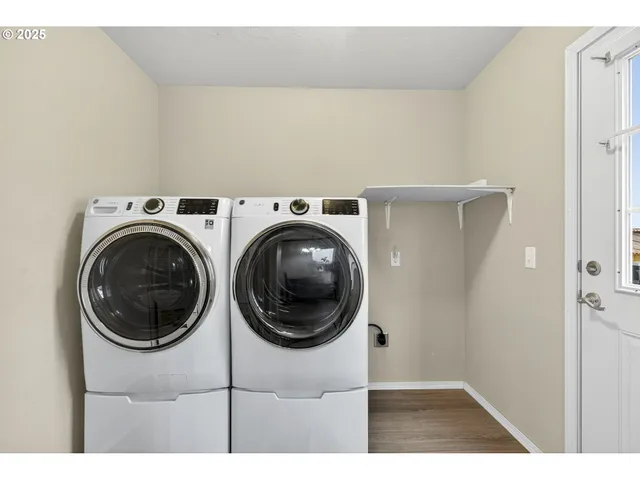 a view of a hallway with washer and dryer
