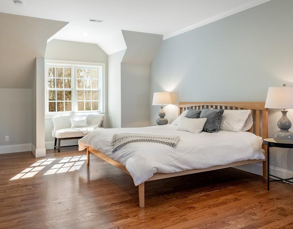 427 Lowell Road Concord, MA 01742 - Photo 19 of 35 a bedroom with a bed and wooden floor