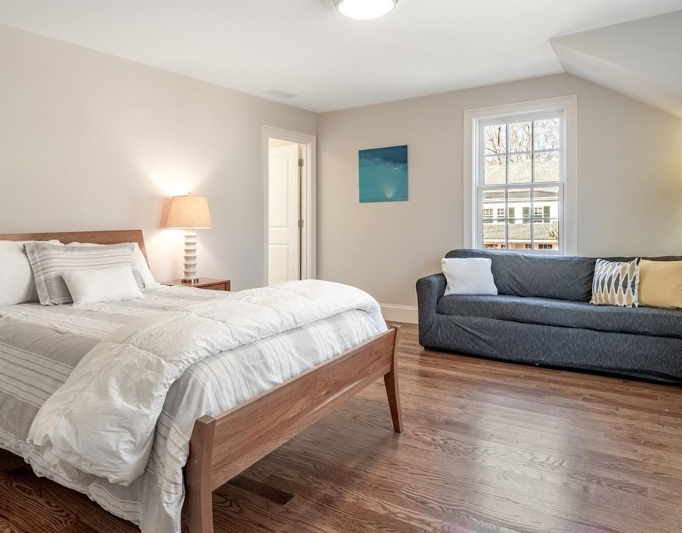 427 Lowell Road Concord, MA 01742 - Photo 23 of 35 a spacious bedroom with a bed couch and a window