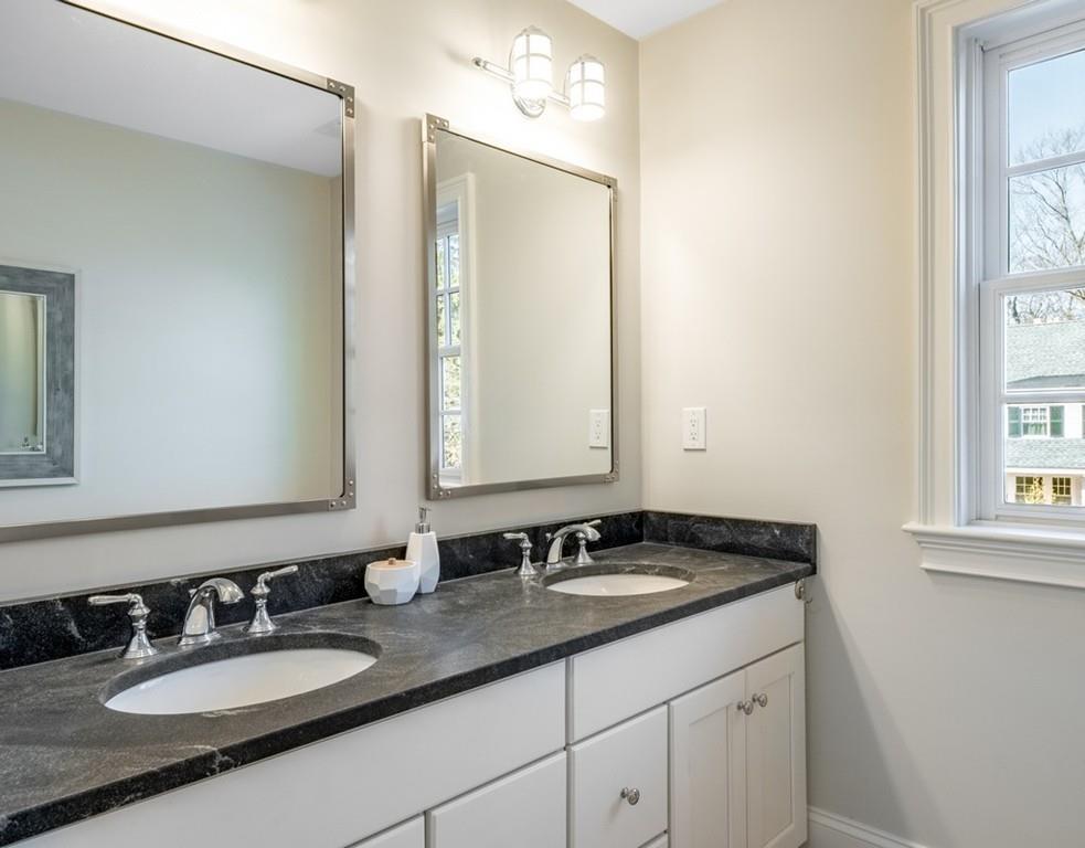 427 Lowell Road Concord, MA 01742 - Photo 26 of 35 a bathroom with a sink double vanity and a mirror