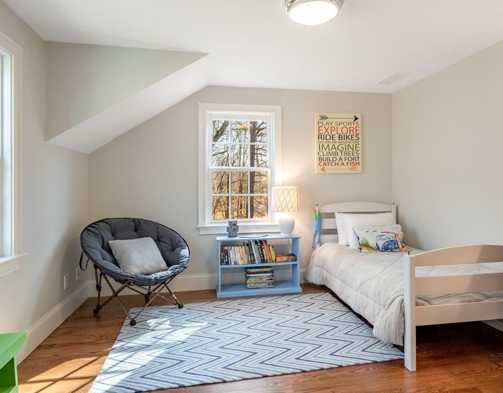 427 Lowell Road Concord, MA 01742 - Photo 27 of 35 a bedroom with a bed and a chair