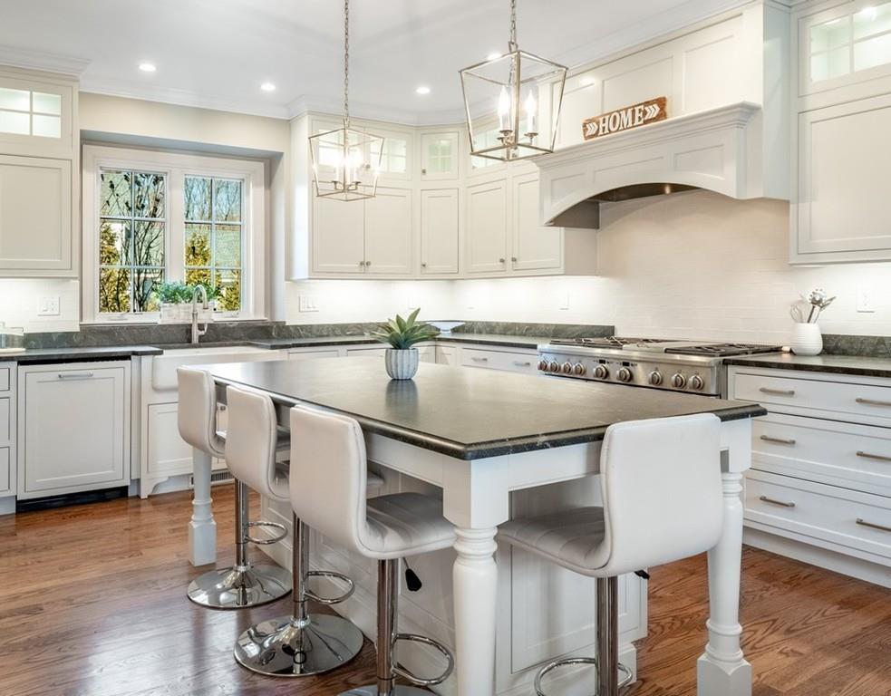 427 Lowell Road Concord, MA 01742 - Photo 4 of 35 a kitchen with a table chairs stove and cabinets