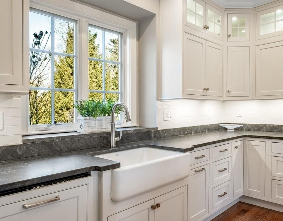 427 Lowell Road Concord, MA 01742 - Photo 5 of 35 a kitchen with granite countertop white cabinets and a window