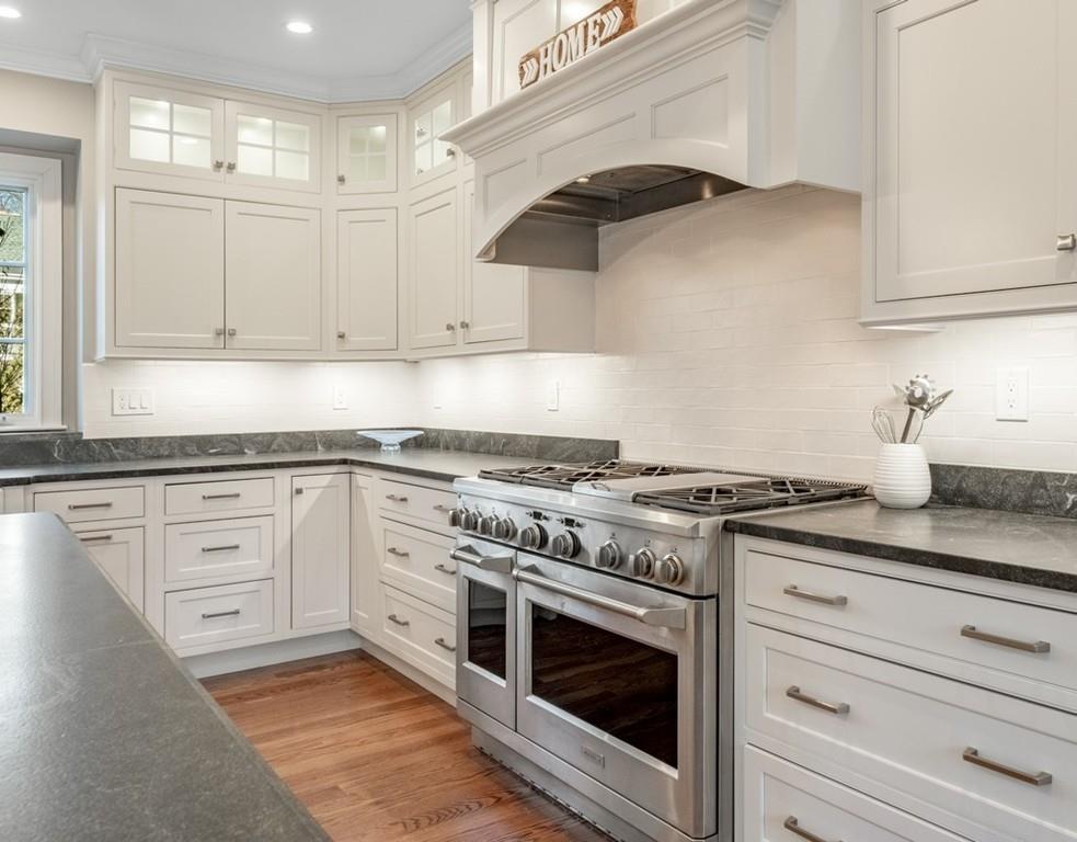 427 Lowell Road Concord, MA 01742 - Photo 6 of 35 a white kitchen with granite countertop stainless steel appliances