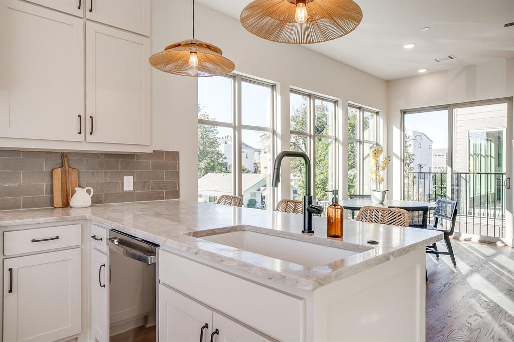 300 Foch Street, Unit 140 Fort Worth, TX 76107 - Photo 12 of 39 a kitchen with stainless steel appliances granite countertop a stove a sink and a granite counter tops with white cabinets