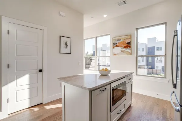 a kitchen with stainless steel appliances granite countertop a stove and a refrigerator