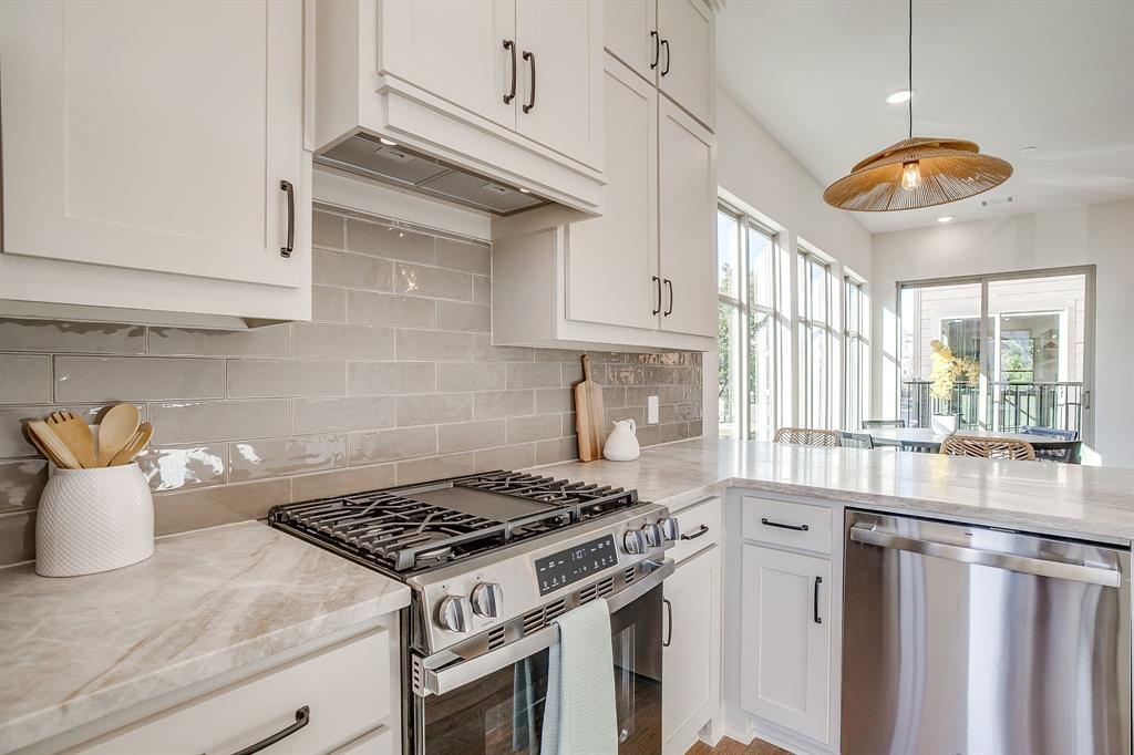 300 Foch Street, Unit 140 Fort Worth, TX 76107 - Photo 18 of 39 a kitchen with stainless steel appliances granite countertop a stove a sink and a white cabinets