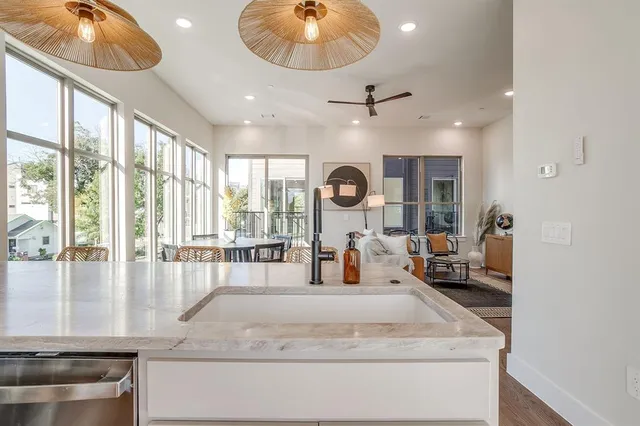 a large kitchen with kitchen island granite countertop a large window
