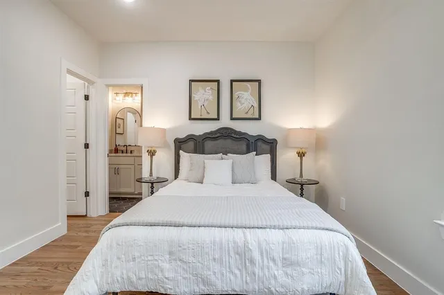 a bedroom with a bed and a night stand