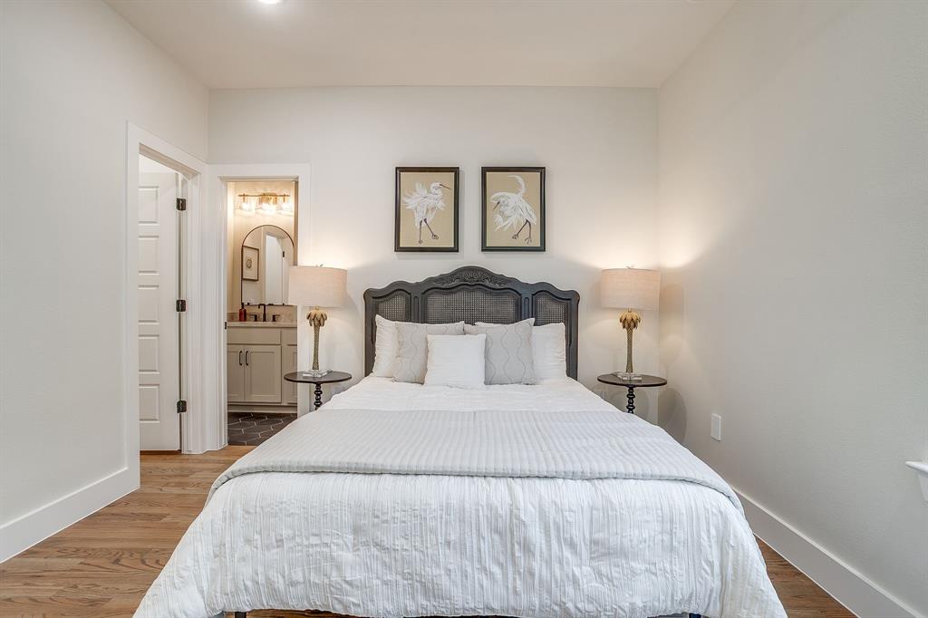 300 Foch Street, Unit 140 Fort Worth, TX 76107 - Photo 25 of 39 a bedroom with a bed and a night stand