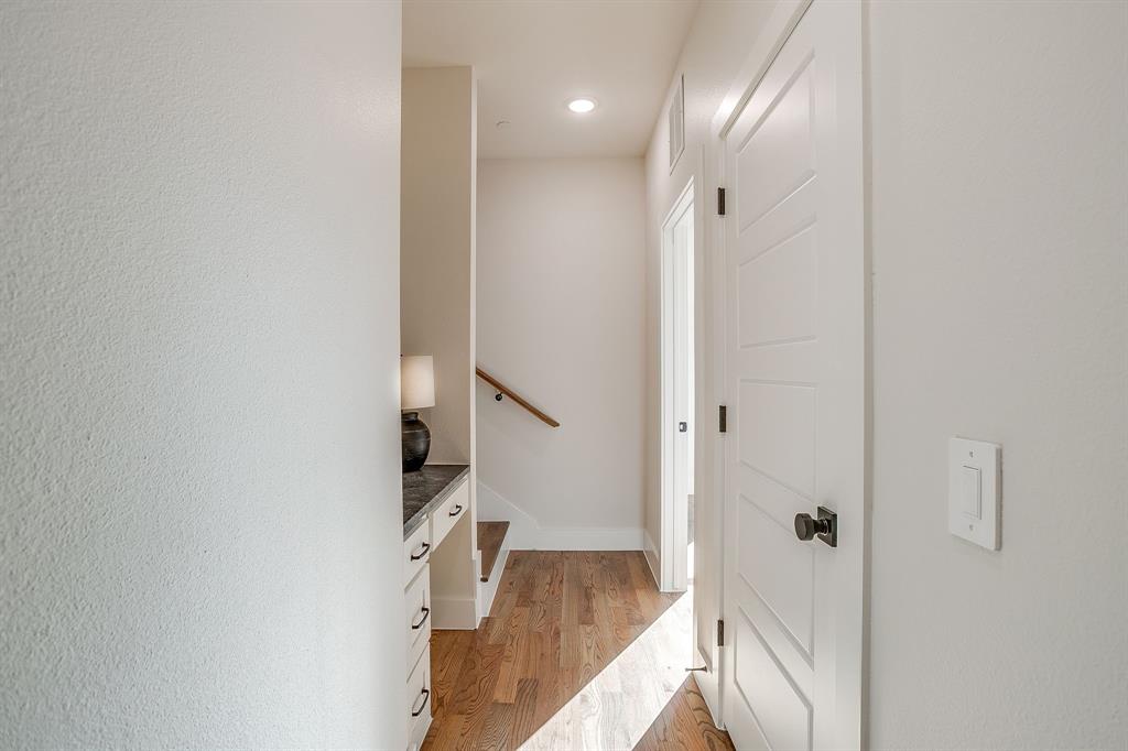 300 Foch Street, Unit 140 Fort Worth, TX 76107 - Photo 29 of 39 a view of a hallway with wooden floor and staircase