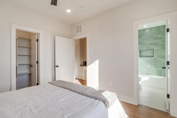 a bedroom with a bed and wooden floor