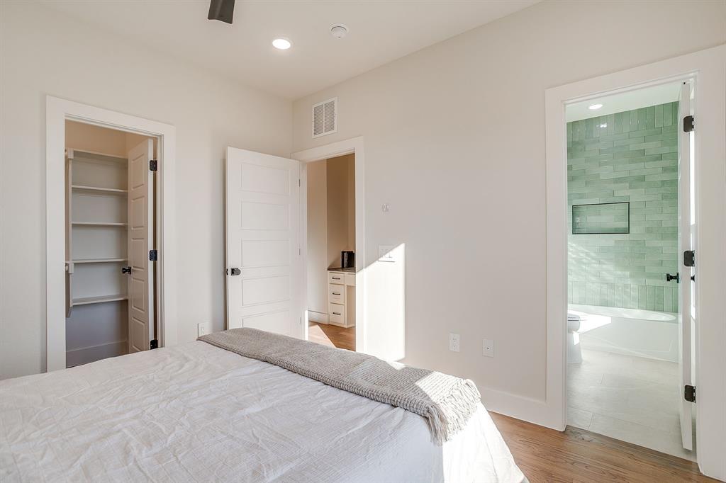 300 Foch Street, Unit 140 Fort Worth, TX 76107 - Photo 31 of 39 a bedroom with a bed and wooden floor