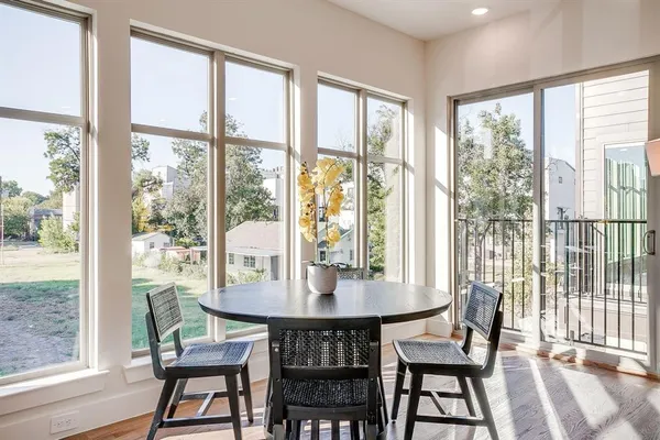 a dining room with furniture window and wooden floor
