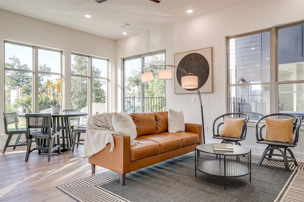 300 Foch Street, Unit 140 Fort Worth, TX 76107 - Photo 7 of 39 a living room with furniture a rug potted plant and a large window