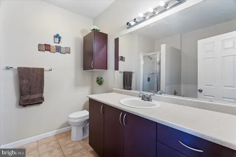 a bathroom with a sink and a mirror with toilet