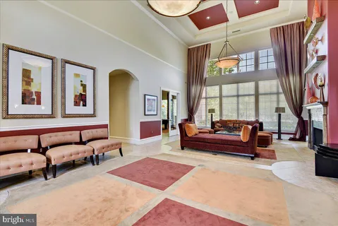 a bedroom with furniture and a large window