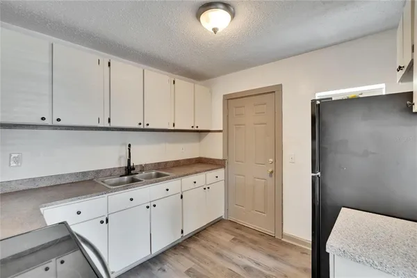 a kitchen with stainless steel appliances granite countertop white cabinets and a granite counter tops