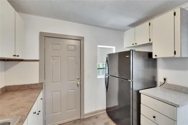 a kitchen with cabinets and stainless steel appliances