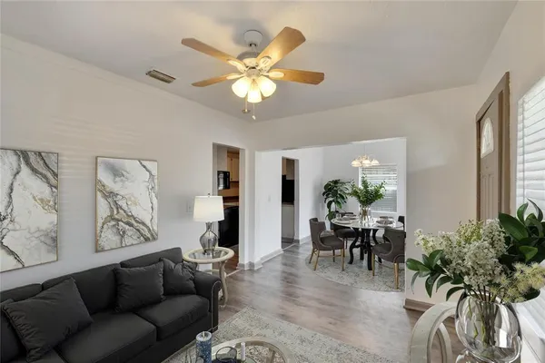 a living room with furniture and a chandelier