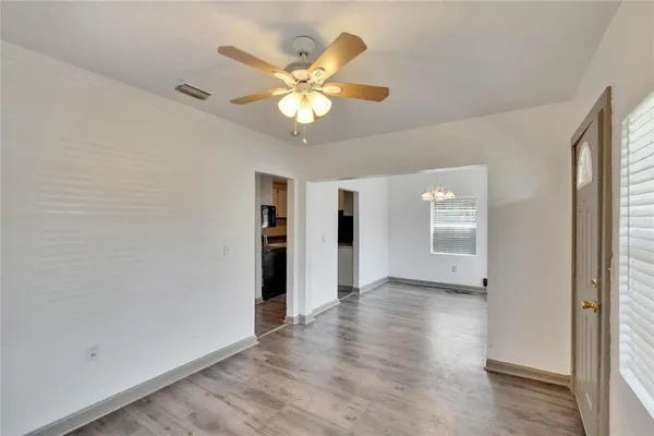 wooden floor in an empty room with a window