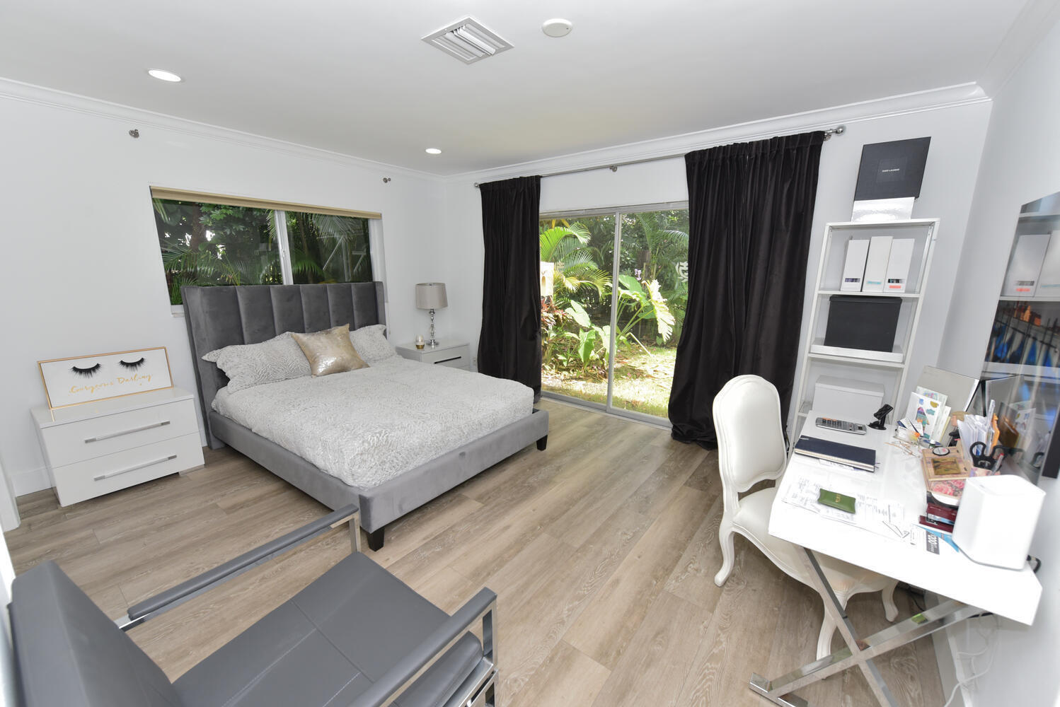 880 Hickory Terrace Boca Raton, FL 33486 - Photo 22 of 38 a bedroom with a bed and wooden floor