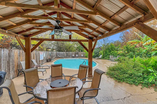 a view of a patio with table and chairs and potted plants