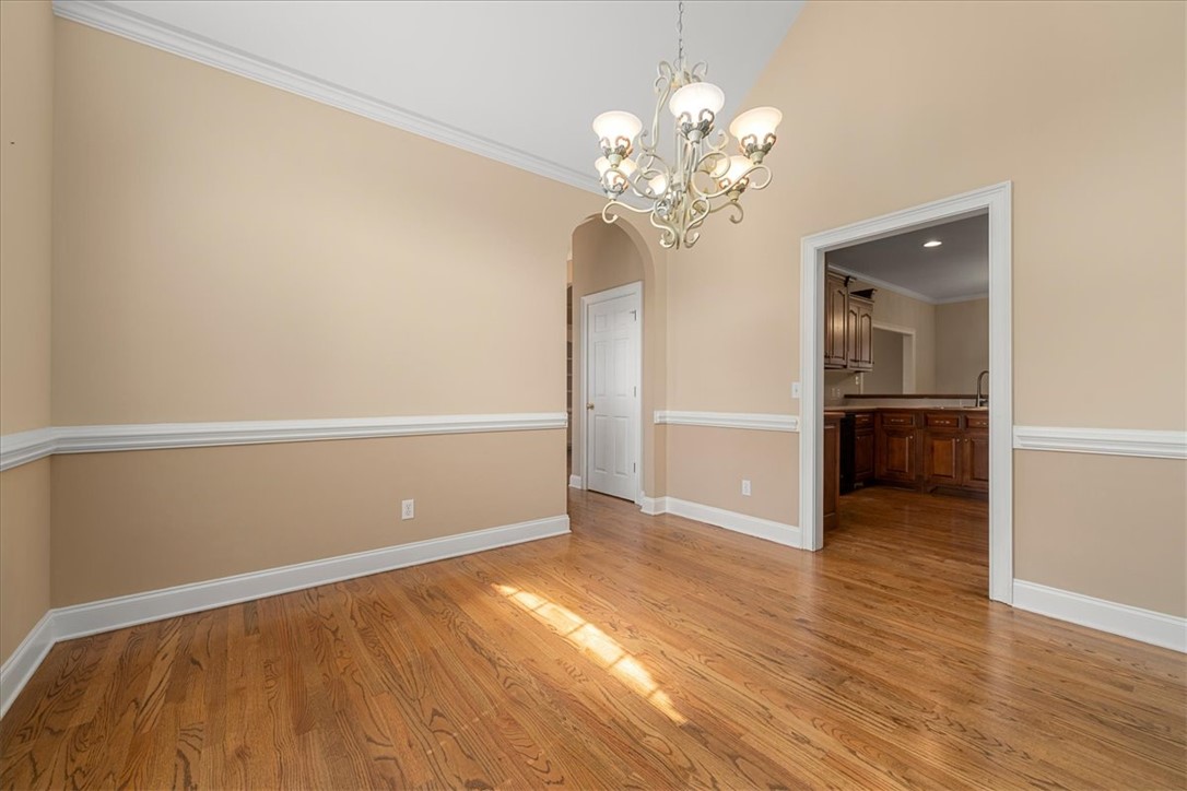 128 Cayman Way Anderson, SC 29621 - Photo 17 of 49 This bright space features rich hardwood floors and an elegant chandelier.