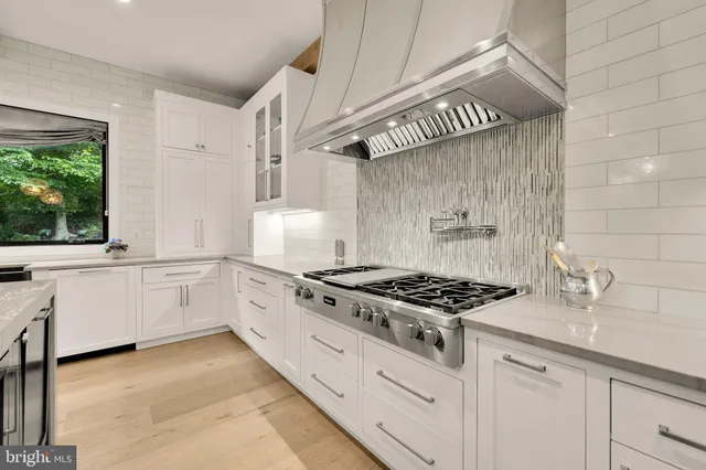 a kitchen with stainless steel appliances a stove and cabinets