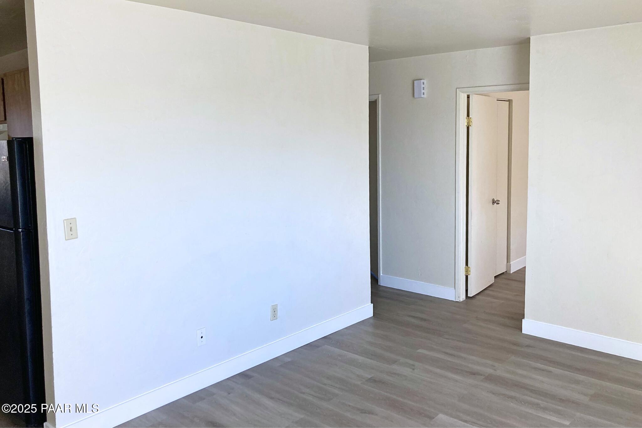 3184 North Tani Road, Unit 12 Prescott Valley, AZ 86314 - Photo 5 of 8 a view of an empty room with wooden floor