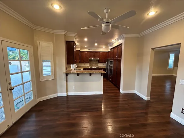 a kitchen with granite countertop wooden cabinets and stainless steel appliances