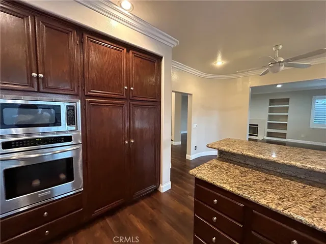 a view of kitchen and hall with a large window