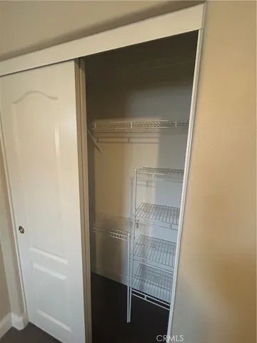 a view of a room with wooden floor and windows in it