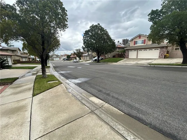 a view of a street with houses on the roadside