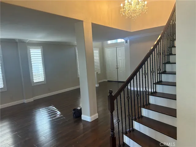a view of entryway with wooden floor and stairs